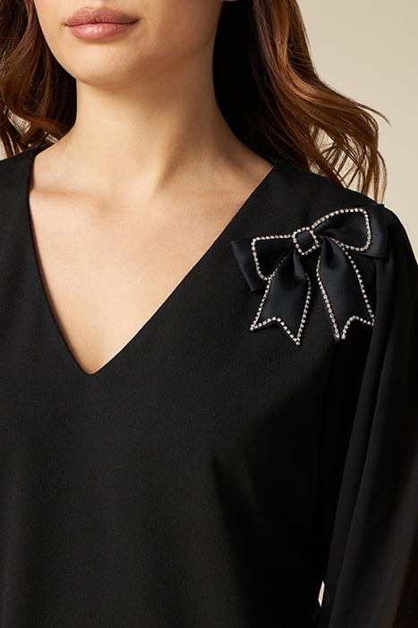 Dual-material dress with brooch 4